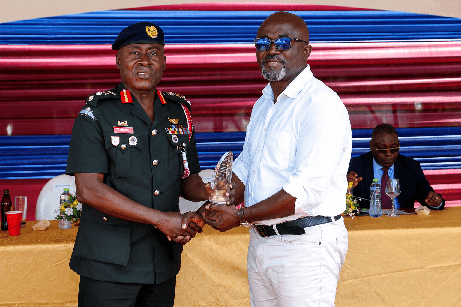 Eric Donkor receives an award on behalf of White Beam Concepts for contribution to the construction of the Hold Fast Conference Hall