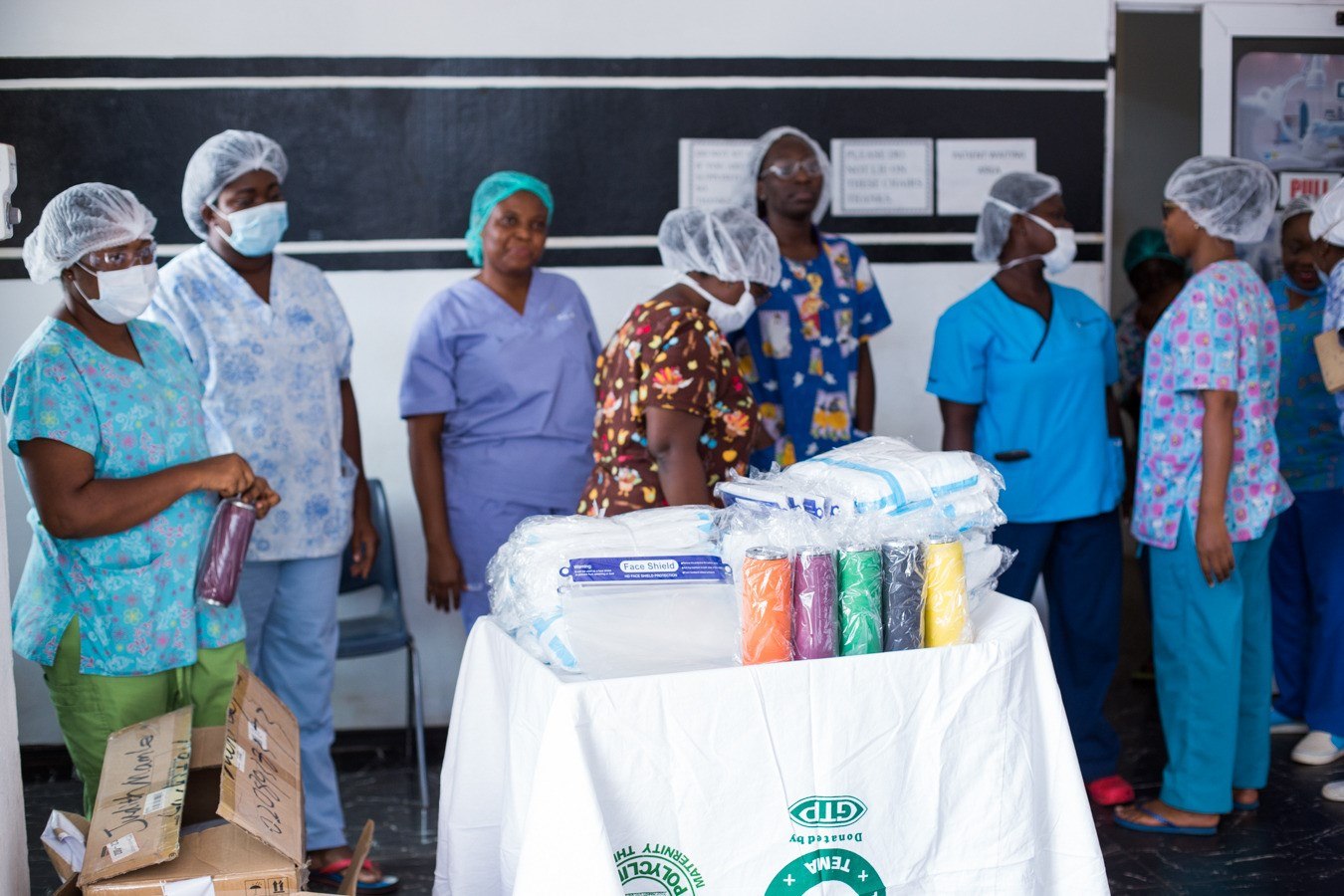 Healthcare workers gathered around donated medical supplies