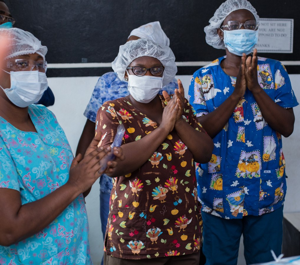 Healthcare team applauding during the White Beam Concepts donation visit