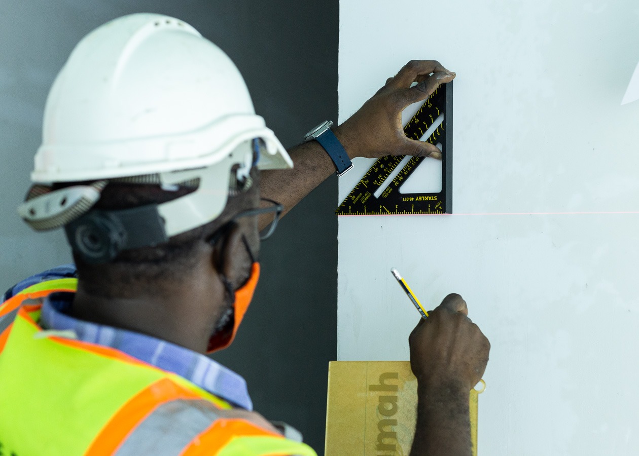 White Beam Concepts team ensuring precise wall alignment